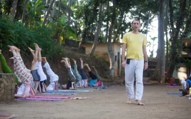 Teaching yoga at the lake side, Kerala